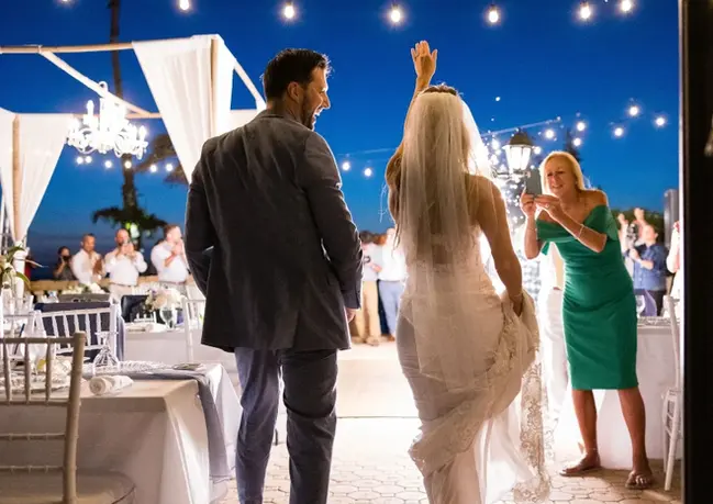 Newlywed couple posing, captured by a wedding photographer and videographer.