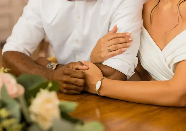 Couple posing at their wedding, captured by a wedding photographer and videographer.