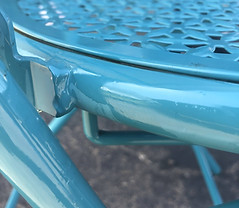 Blue patio table closeup restored with Everbrite Coating