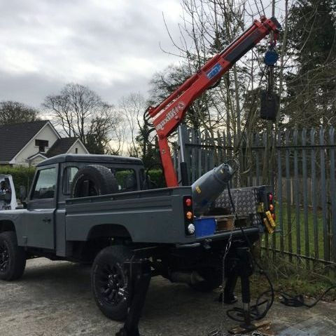 unloading submersible sewerage pump into tank