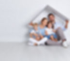 Happy family sittting underneath a mini house roof