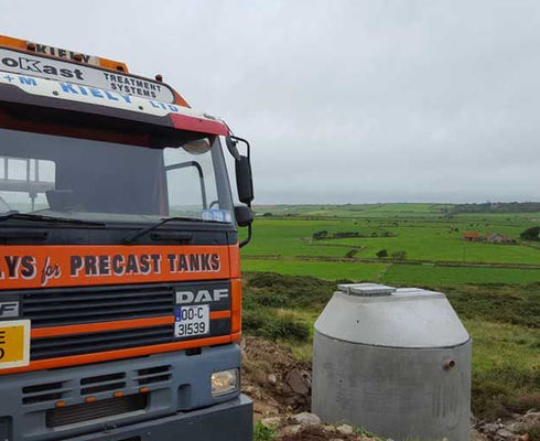 W & M Kiely Ltd. Lorry by a precast tank