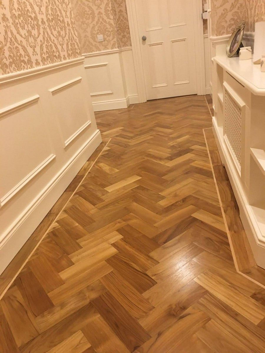 Solid teak herringbone with maple inlay floor in a domestic hallway