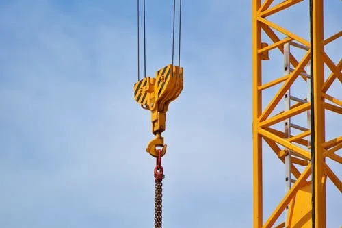 a yellow tower crane