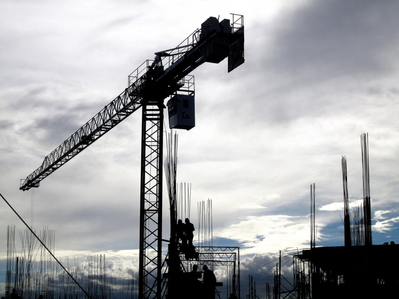 A group of workers and a crane