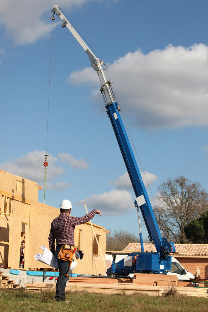 A foreman using a load chart to give instructions to a crane operator.