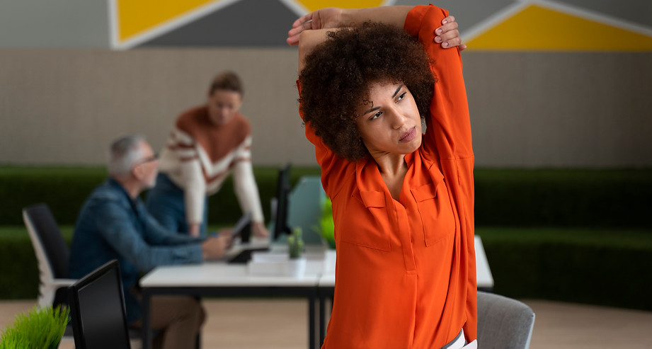 woman-office-stretching-work-day.jpg