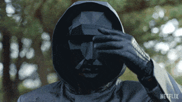 an animated gif of the Front Man removing his mask and hood