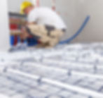 man installing heating pipes