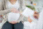 A pregnant woman holding her belly