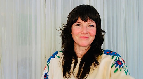Woman with long dark hair, smiling