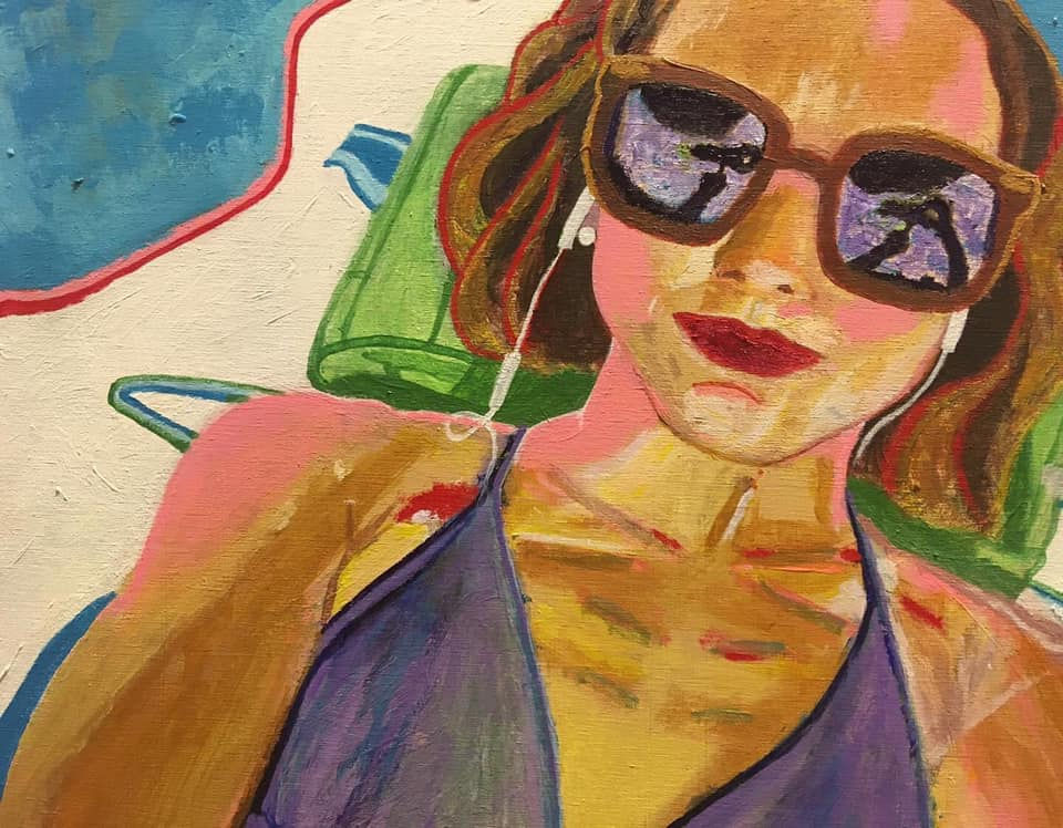 Lying on beach towel self-portrait in sunglasses and bikini