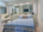 Guest Bedroom with ceiling fan, ample lighting, and TV 