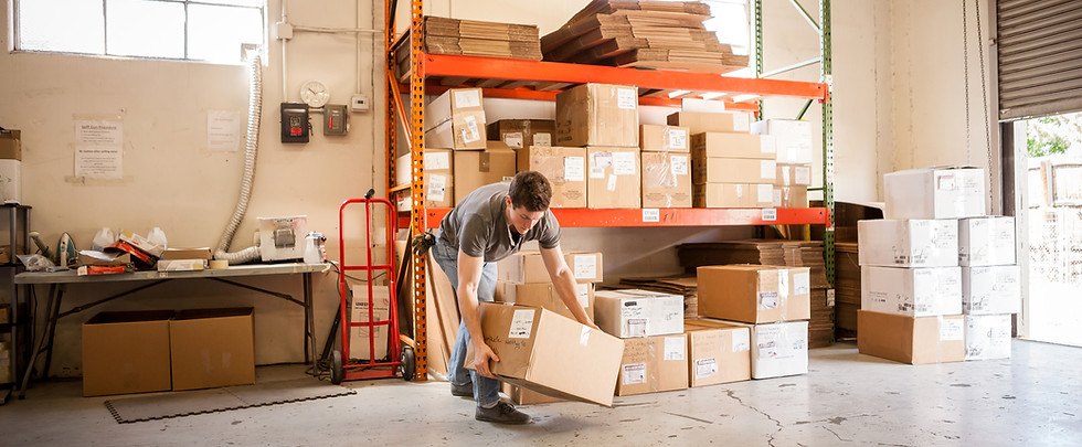 Worker Lifting Cardboard Box