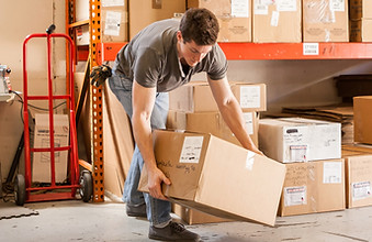 Worker Lifting Cardboard Box