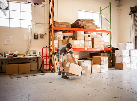 Worker Lifting Cardboard Box
