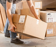 Worker Lifting Cardboard Box