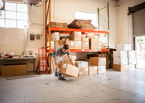 Worker Lifting Cardboard Box