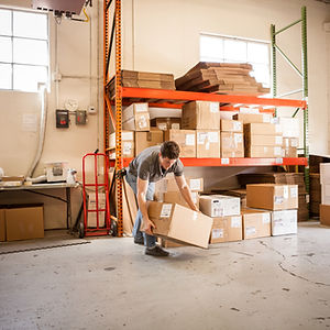 Worker Lifting Cardboard Box