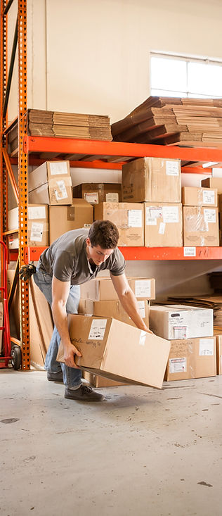 Worker Lifting Cardboard Box