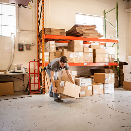 Worker Lifting Cardboard Box