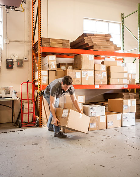 Worker Lifting Cardboard Box