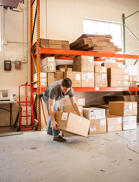 Worker Lifting Cardboard Box