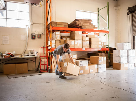 Worker Lifting Cardboard Box