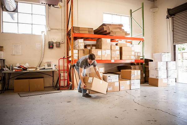 Worker Lifting Cardboard Box