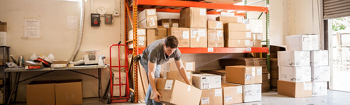 Worker Lifting Cardboard Box