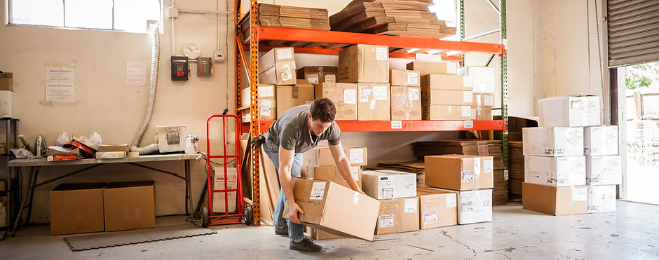 Worker Lifting Cardboard Box