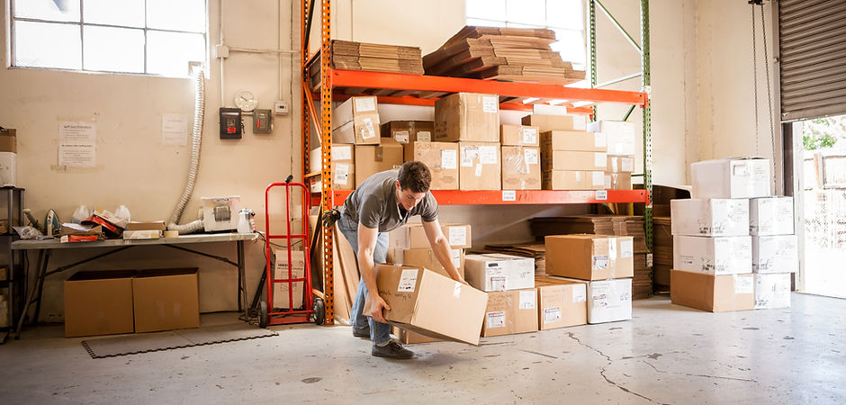 Worker Lifting Cardboard Box