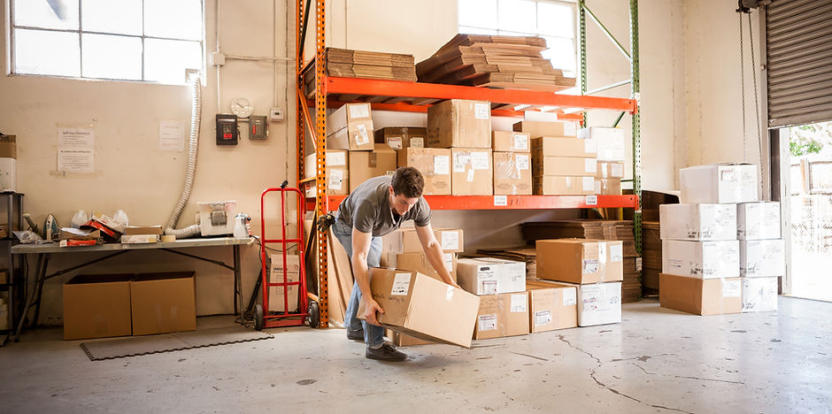 Worker Lifting Cardboard Box