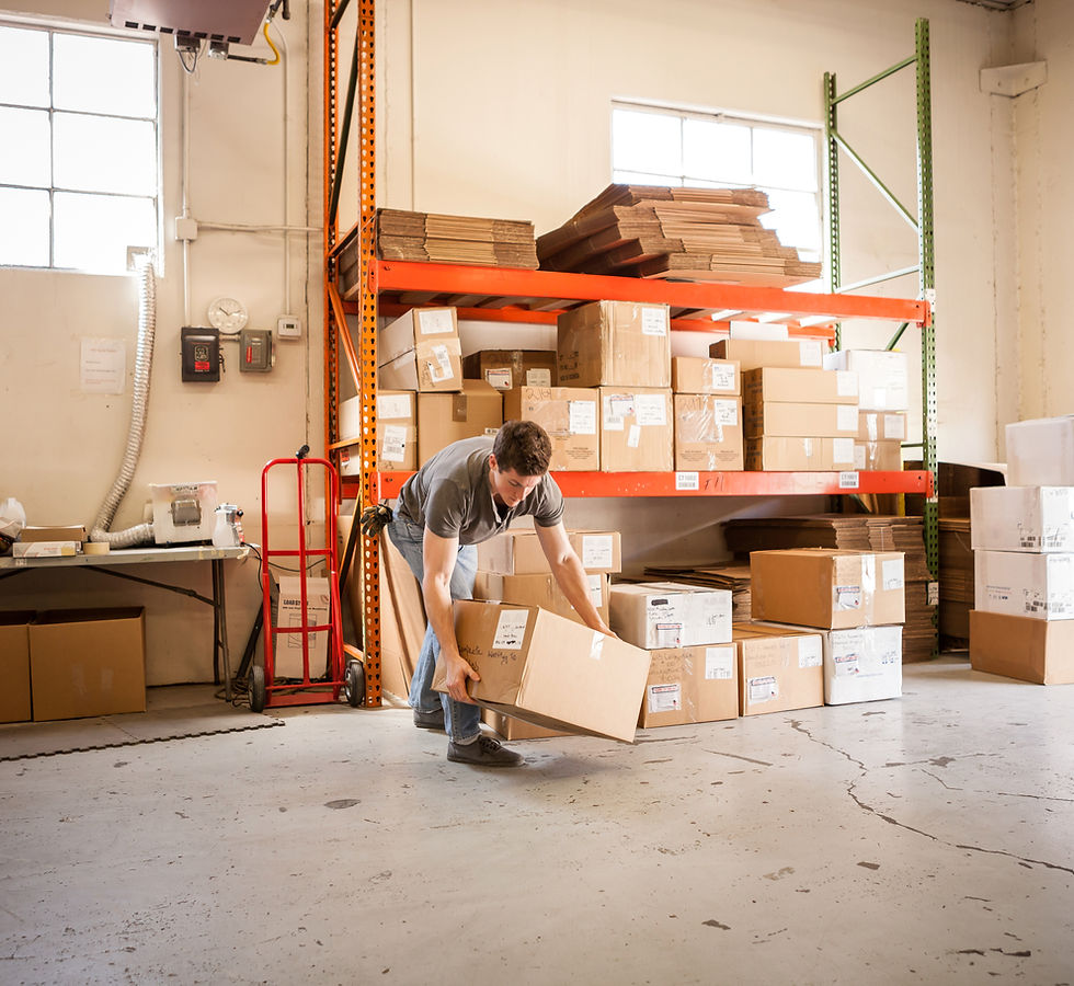 Worker Lifting Cardboard Box