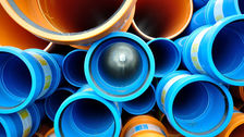 Underground pipes (blue and orange) showing black pipe seals