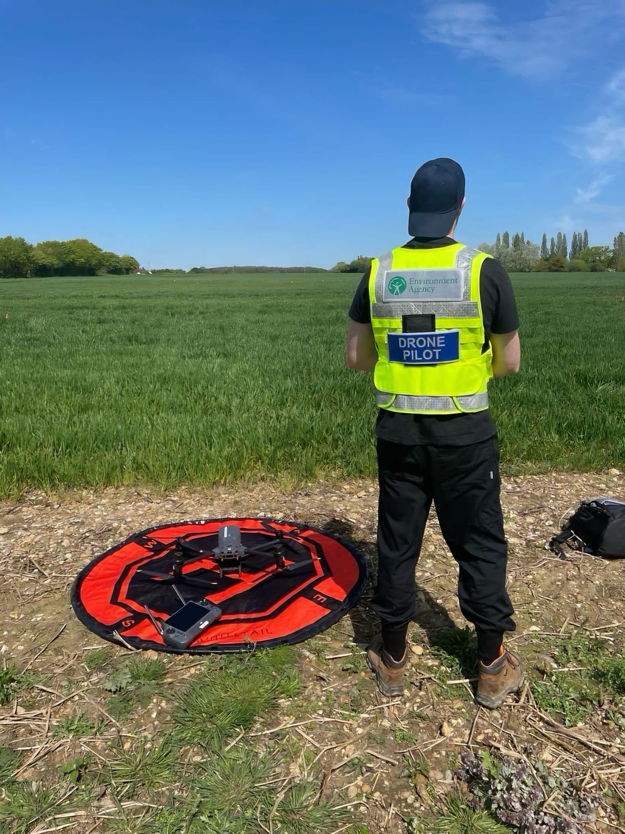 EA Drone Pilot wearing yellow hi viz vest 