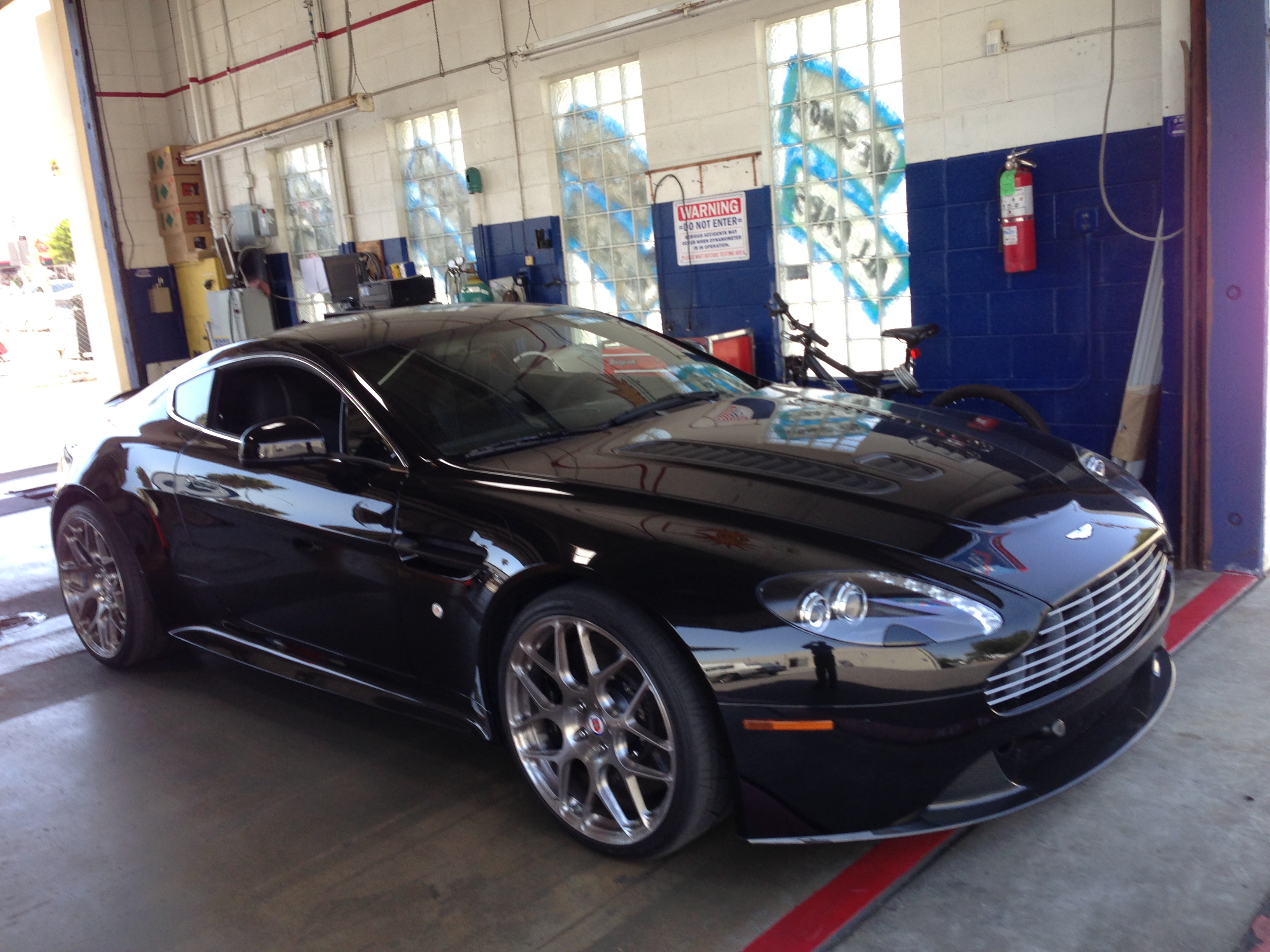 Black Aston Martin in the test bay