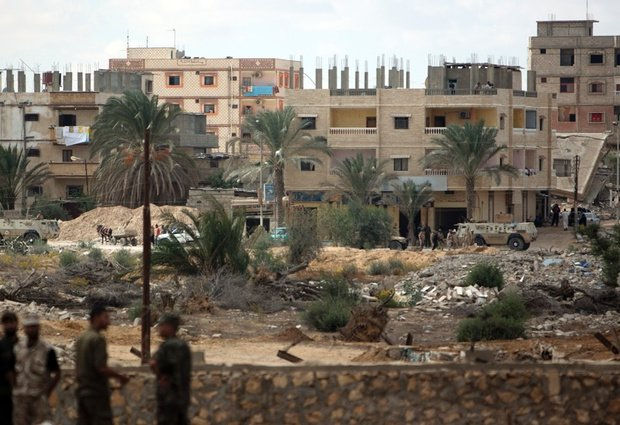 Egyptians search useful materials in the rubble of their destroyed houses on the
