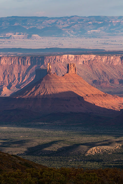 Photo of a sunrise view of Castleton Tower and Priest and Nuns from foothills of Mt. Waas and Mt. La Sal, Utah