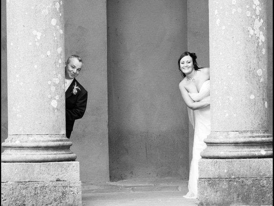 Bride & Groom behind pillars