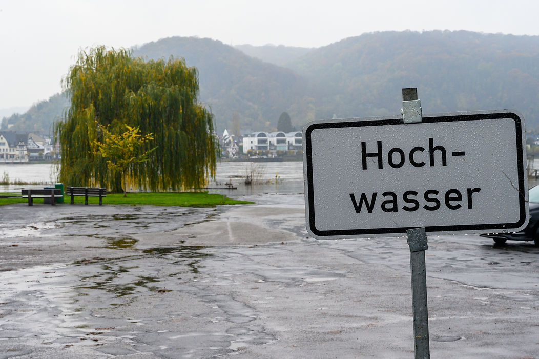 A sign in German saying _Hochwasser_ meaning high water or flooding with the Rhine river a
