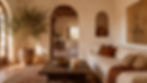 Mediterranean living room with whitewashed plaster walls, arched doorway, potted olive tree in aged terracotta urn and warm golden afternoon light