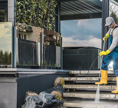 caucasian-homeowner-pressure-washing-his-garden-paths.jpg