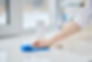 female-hand-with-washing-sponge-cleaning-stone-surface-kitchen-tabletop-photo-with-shallow