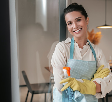domestic-routine-smiling-housewife-apron-standing-kitchen.jpg