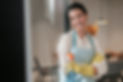 domestic-routine-smiling-housewife-apron-standing-kitchen.jpg