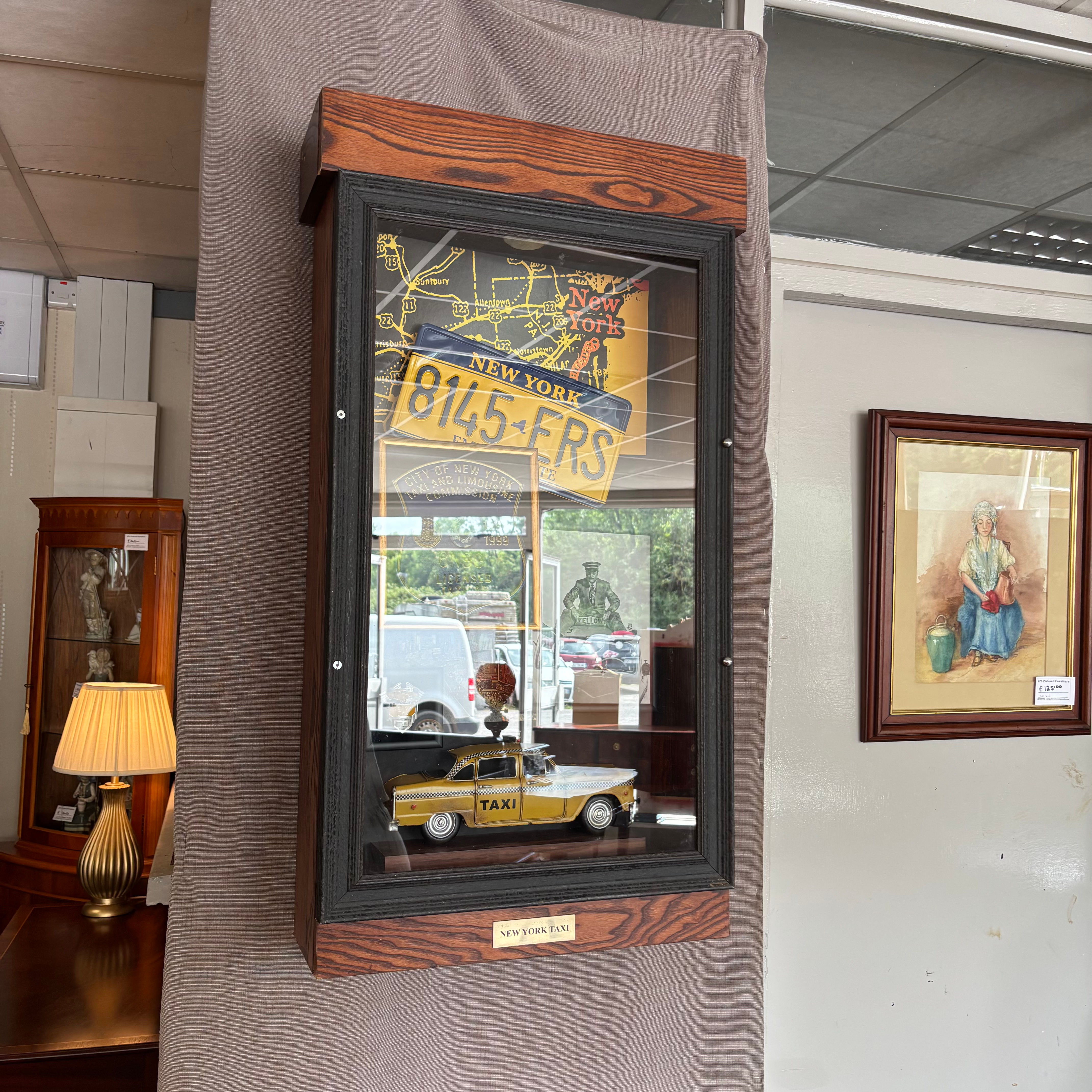 A cased diorama of items relating to New York taxis