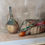 Thumbnail: Early 20th century still life watercolours, depicting a straw wrapped bottle