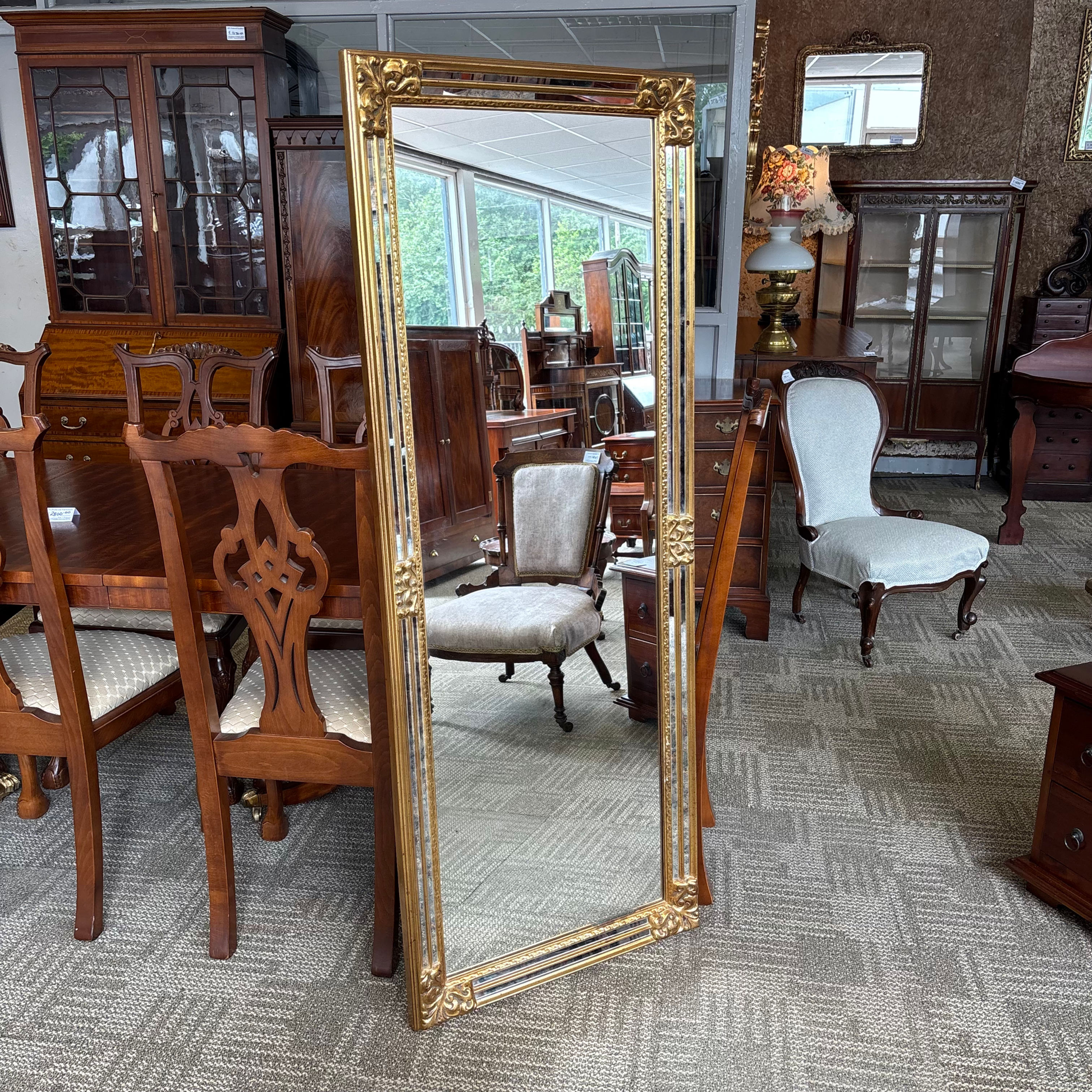 Baroque-inspired gold frame with intricate decorative corner detailing
