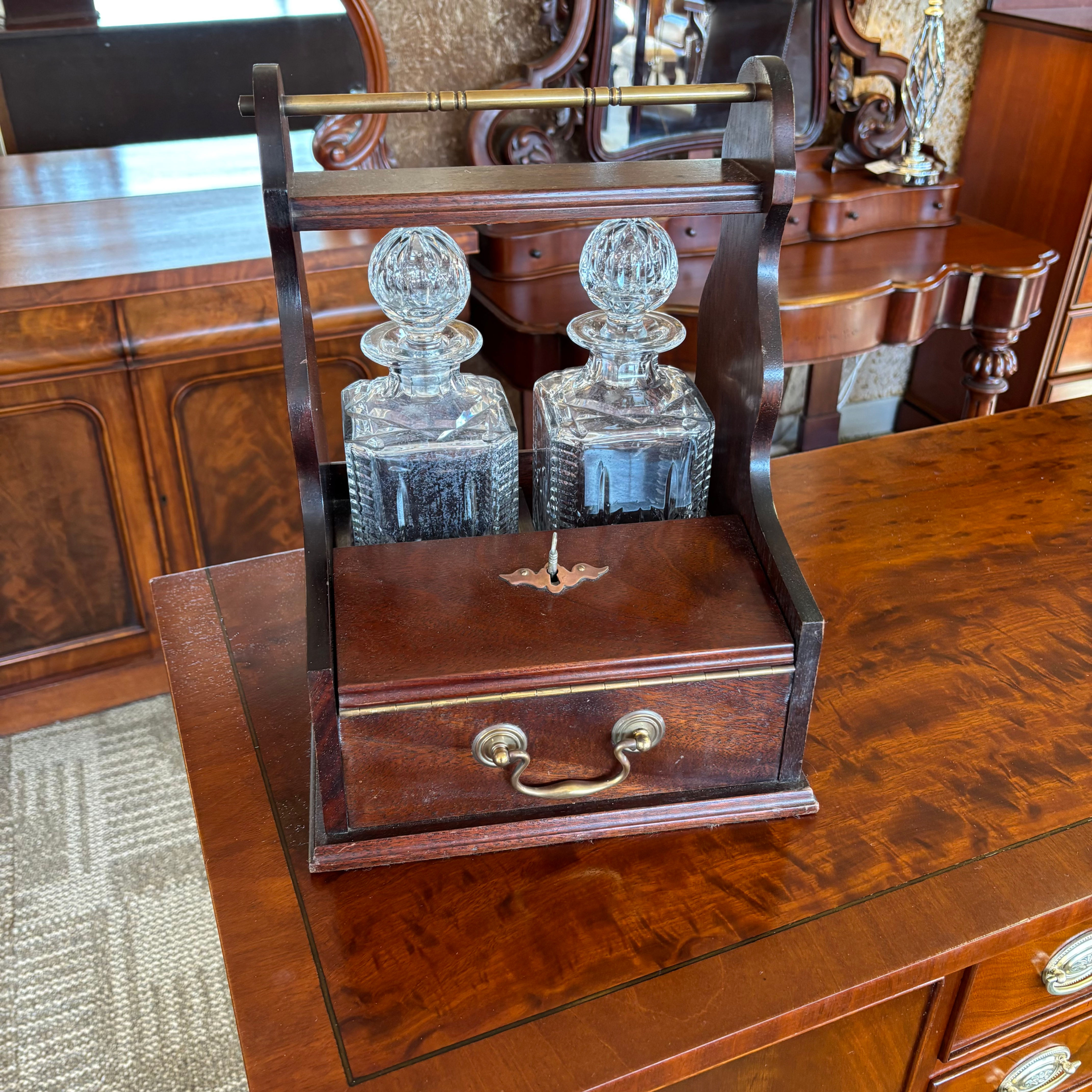 Vintage mahogany tantalus set, includes two crystal decanters & two glasses